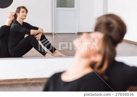 Cute joyful dancer looking at his reflection 27650016
