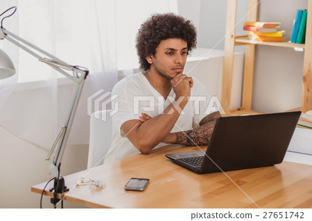 Man looking intently at the laptop Man looking intently at the laptop 27651742