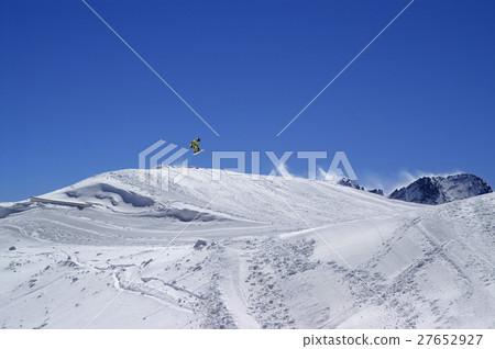 Snowboarder jumping in terrain park at ski resort 27652927