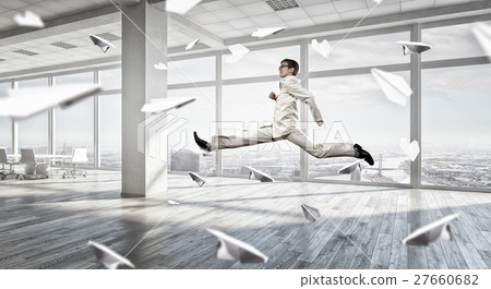 Jumping businessman in office Jumping businessman in office 27660682