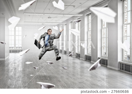 Jumping businessman in office Jumping businessman in office 27660686