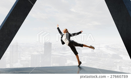 Dancing businesswoman in office Dancing businesswoman in office 27660789
