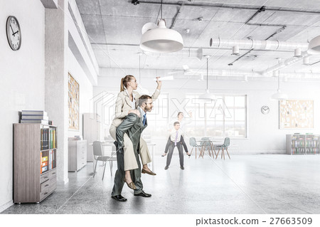 Businesswoman riding colleague back Businesswoman riding colleague back 27663509