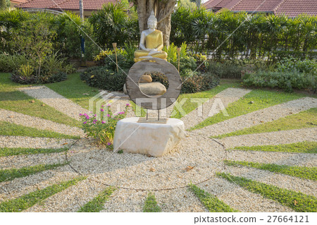 silver buddha statue with golden robe in garden silver buddha statue with golden robe in garden 27664121