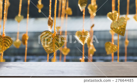 Gold pho leaves hanging on golden tree (blur image) with selected focus wood table for display your product 27664485