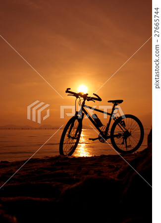 Silhouette of bicycle on the beach against sunset Silhouette of bicycle on the beach against sunset 27665744
