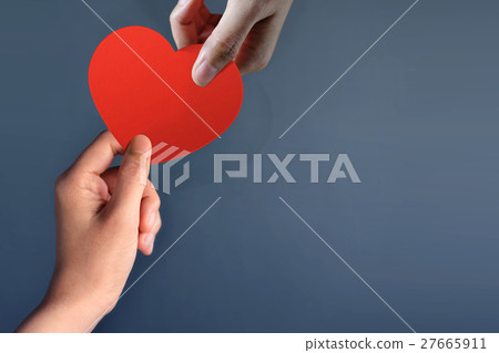 Hand giving Red Heart Paper cuts to another one 27665911
