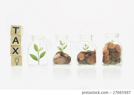 tax message on wood block, stacking gold coins. 27665987