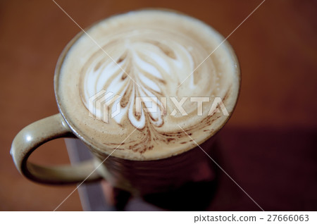 The leaf art on the top of latte coffee cup with r 27666063
