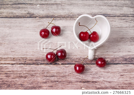 Cherries Chile and Heart-shaped mug on wooden. 27666325