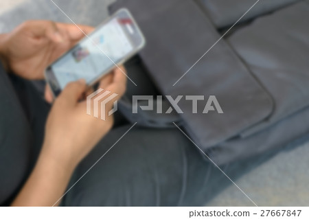 Blurred abstract background of hand use smartphone Blurred abstract background of hand use smartphone 27667847