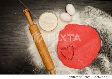 Red dough to form cut-out hearts and flour Red dough to form cut-out hearts and flour 27673432