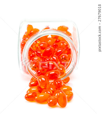 Red supplement capsules spill out from bottle Red supplement capsules spill out from bottle 27679018