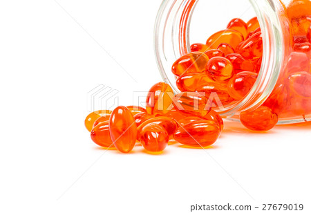 Red supplement capsules spill out from bottle Red supplement capsules spill out from bottle 27679019