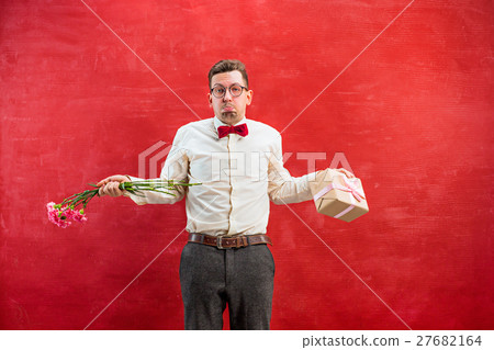 Young young funny man with flowers and gift 27682164