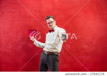 Young funny man with abstract heart and clock 27682176