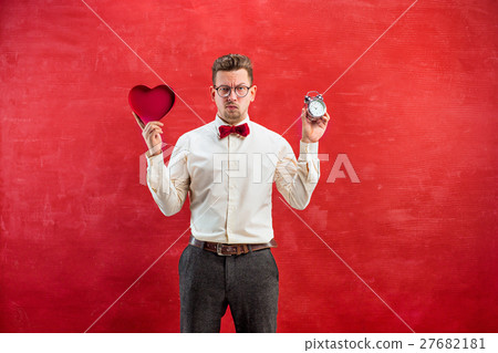Young funny man with abstract heart and clock 27682181
