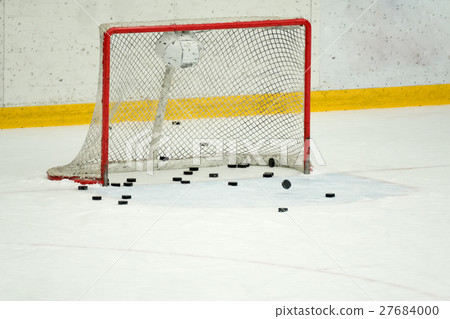 Many pucks in the hockey gates. 27684000