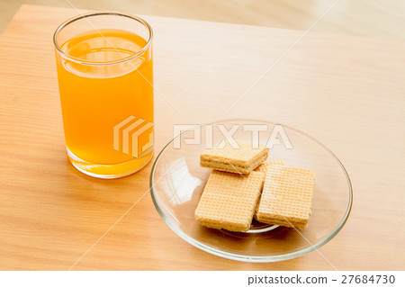Orange juice and Wafer on the wooden table 27684730