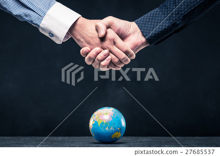Businessman's handshake and global 27685537