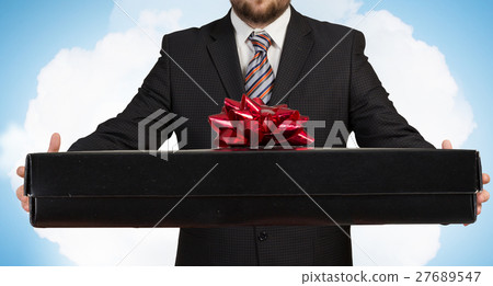 Businessman hold gift box Businessman hold gift box 27689547