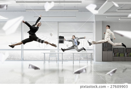 Dancing businesspeople in office room 27689903