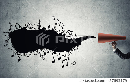 Hand of businesswoman holding red paper trumpet against concrete background 27693179