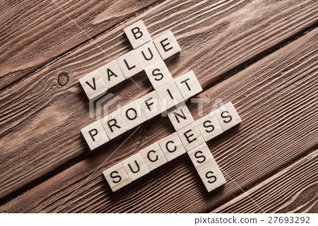 Conceptual business keywords on table with elements of game making crossword 27693292