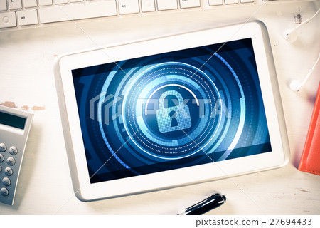Web security and technology concept with tablet pc on wooden table 27694433