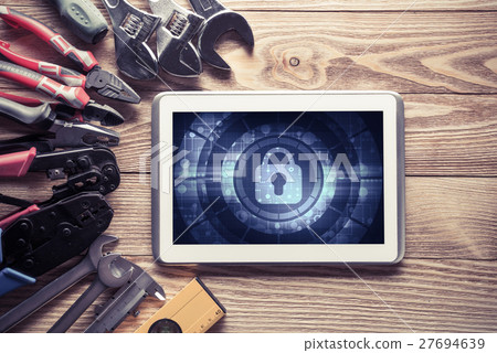 Web security and technology concept with tablet pc on wooden table 27694639