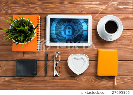 Web security and technology concept with tablet pc on wooden table Web security and technology concept with tablet pc on wooden table 27695595