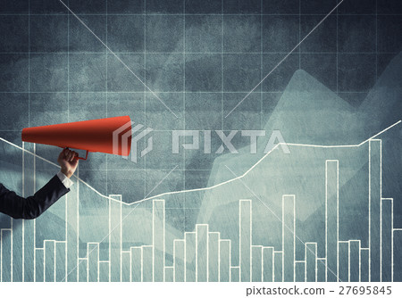 Hand of businesswoman holding red paper trumpet against graphs background Hand of businesswoman holding red paper trumpet against graphs background 27695845