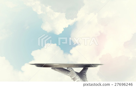 Waiter holding empty silver platter ready for product or item placement 27696246