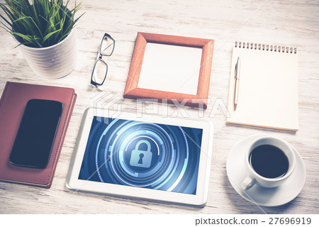 Web security and technology concept with tablet pc on wooden table 27696919