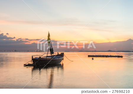 Small fishing boats on the sea during sunset  27698210