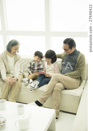 Grandparents and grandchildren sitting on the sofa 27698422