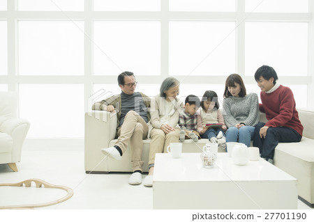 Three generations families using a tablet PC sitting on the sofa Three generations families using a tablet PC sitting on the sofa 27701190