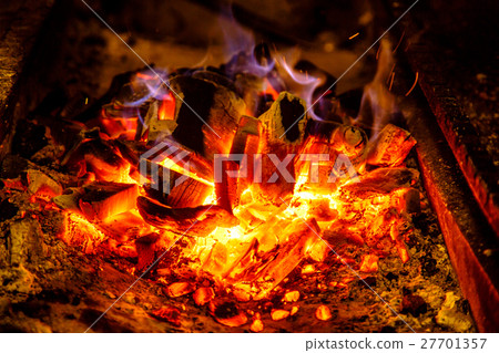 Ignite the coals on the grill for cooking BBQ. 27701357