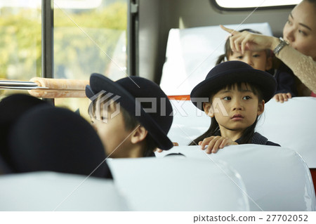 Children aboard a bus service bus 27702052