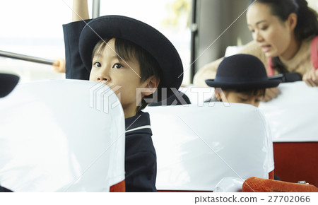 Children aboard a bus service bus 27702066