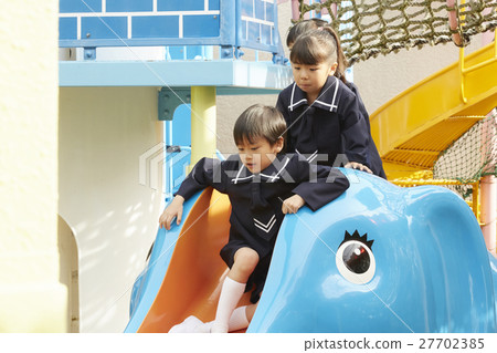 Children playing with playground equipment 27702385