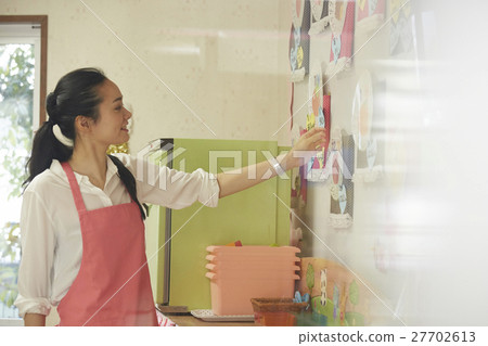 A woman in an apron A woman in an apron 27702613