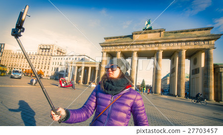 Girl getting a selfie in front of the Brandenburg Gate 27703457