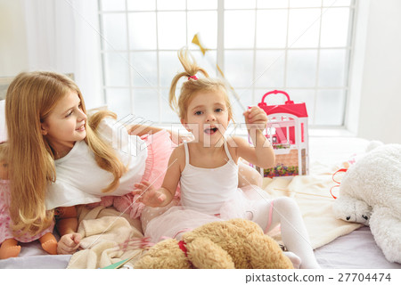 Happy girls playing in bedroom Happy girls playing in bedroom 27704474