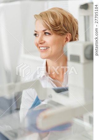 Smiling female doctor beside devices Smiling female doctor beside devices 27705184