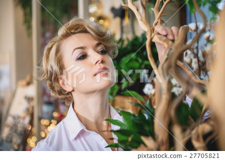 Woman working in flower shop Woman working in flower shop 27705821