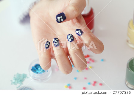 A woman who is nailing A woman who is nailing 27707586