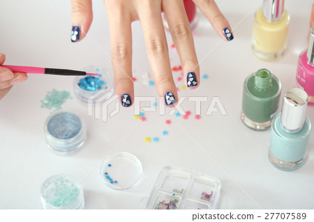 A woman who is nailing 27707589