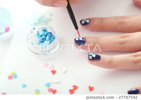 A woman who is nailing A woman who is nailing 27707592