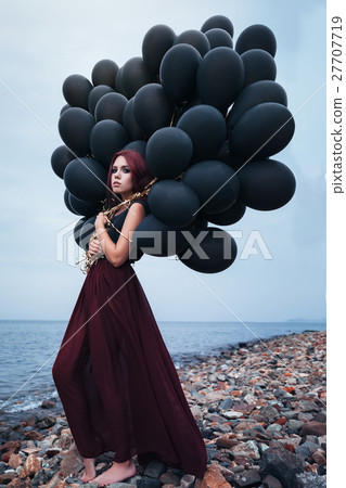 Beautiful girl walking with black balloons 27707719